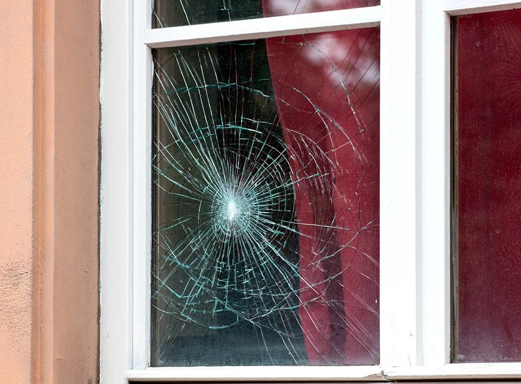 Glazier replacing damaged glass to improve security and insulation